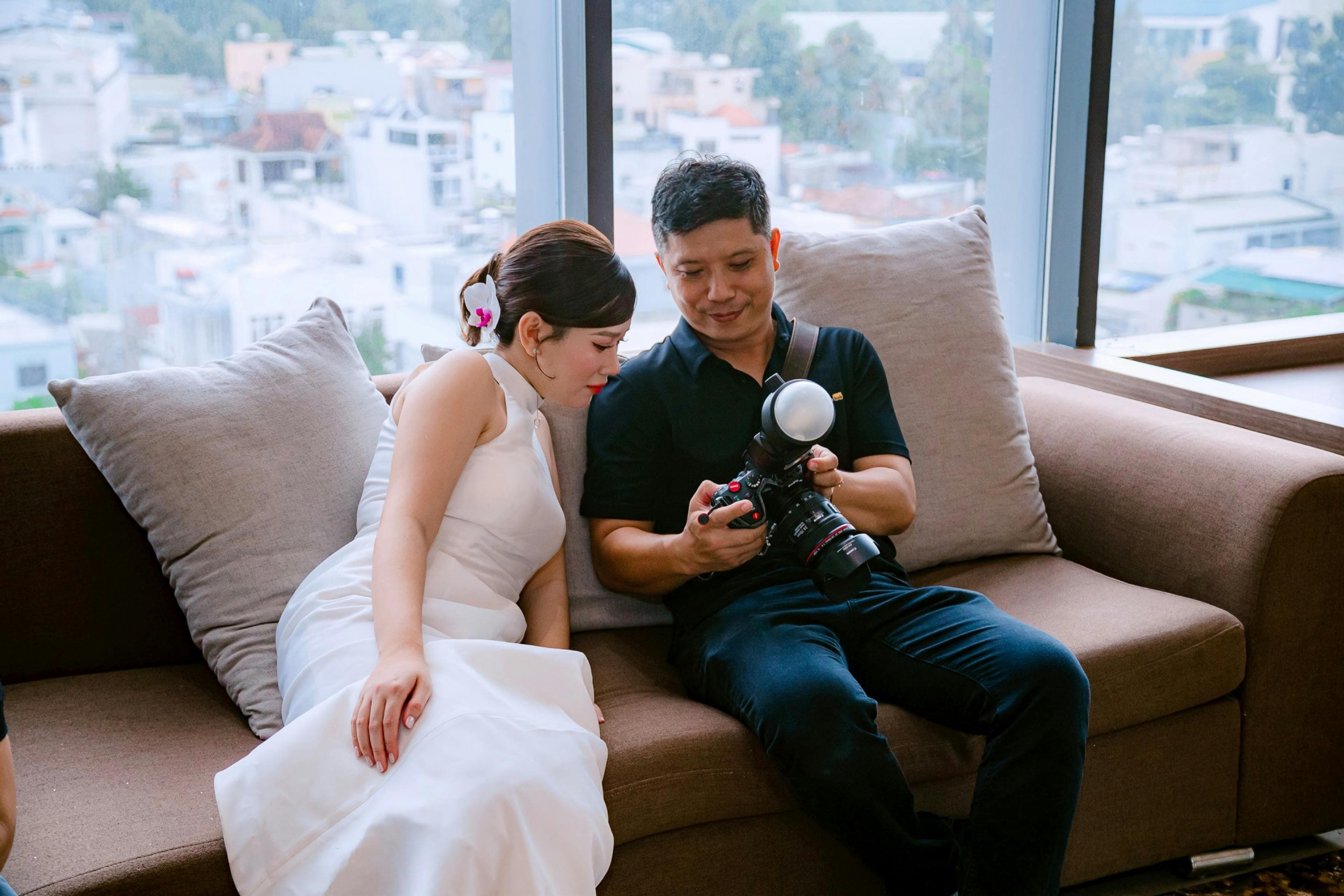 Wedding photographer reviewing a shot list with a couple before a ceremony