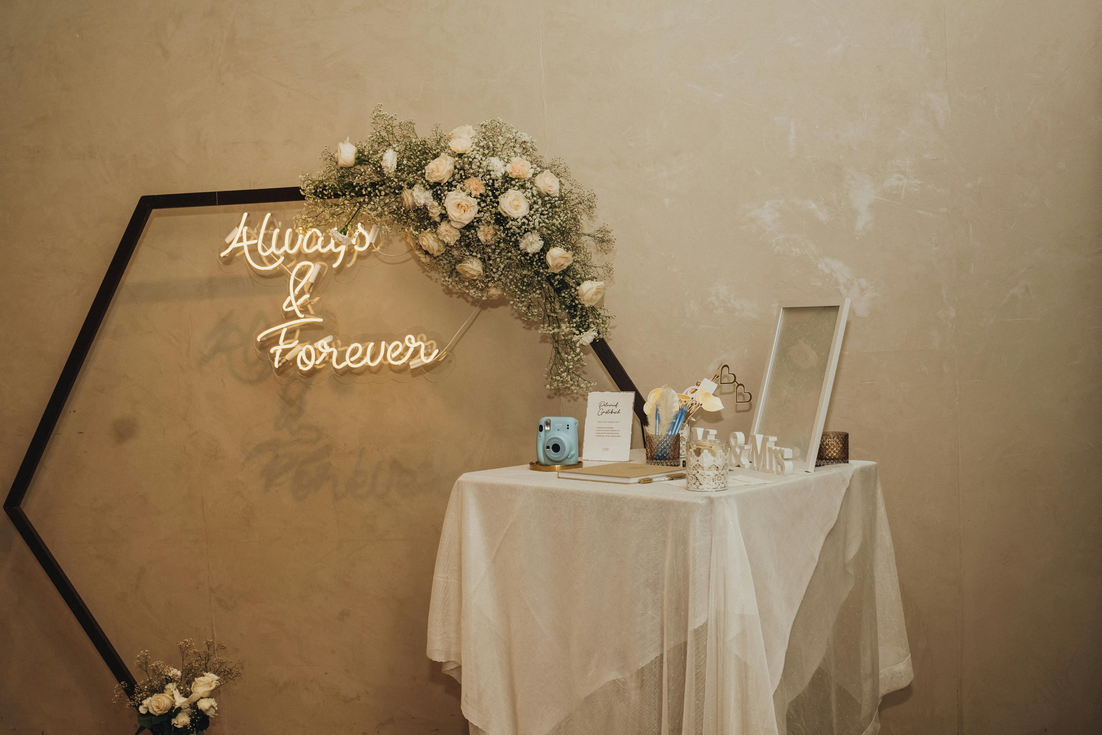 Disposable cameras on wedding reception tables with flowers and place settings