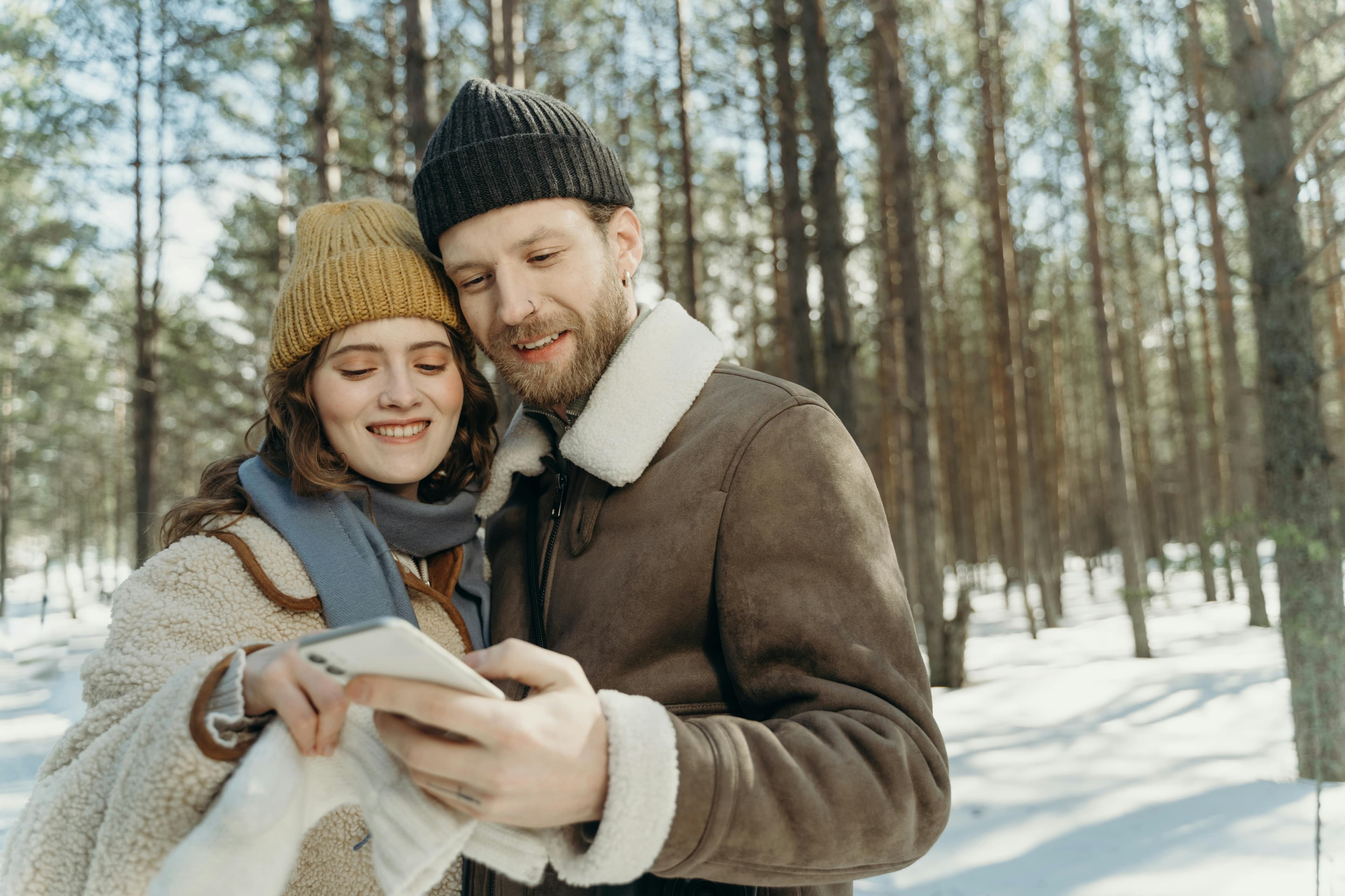 Couple looking at hundreds of guest photos on a phone after their wedding
