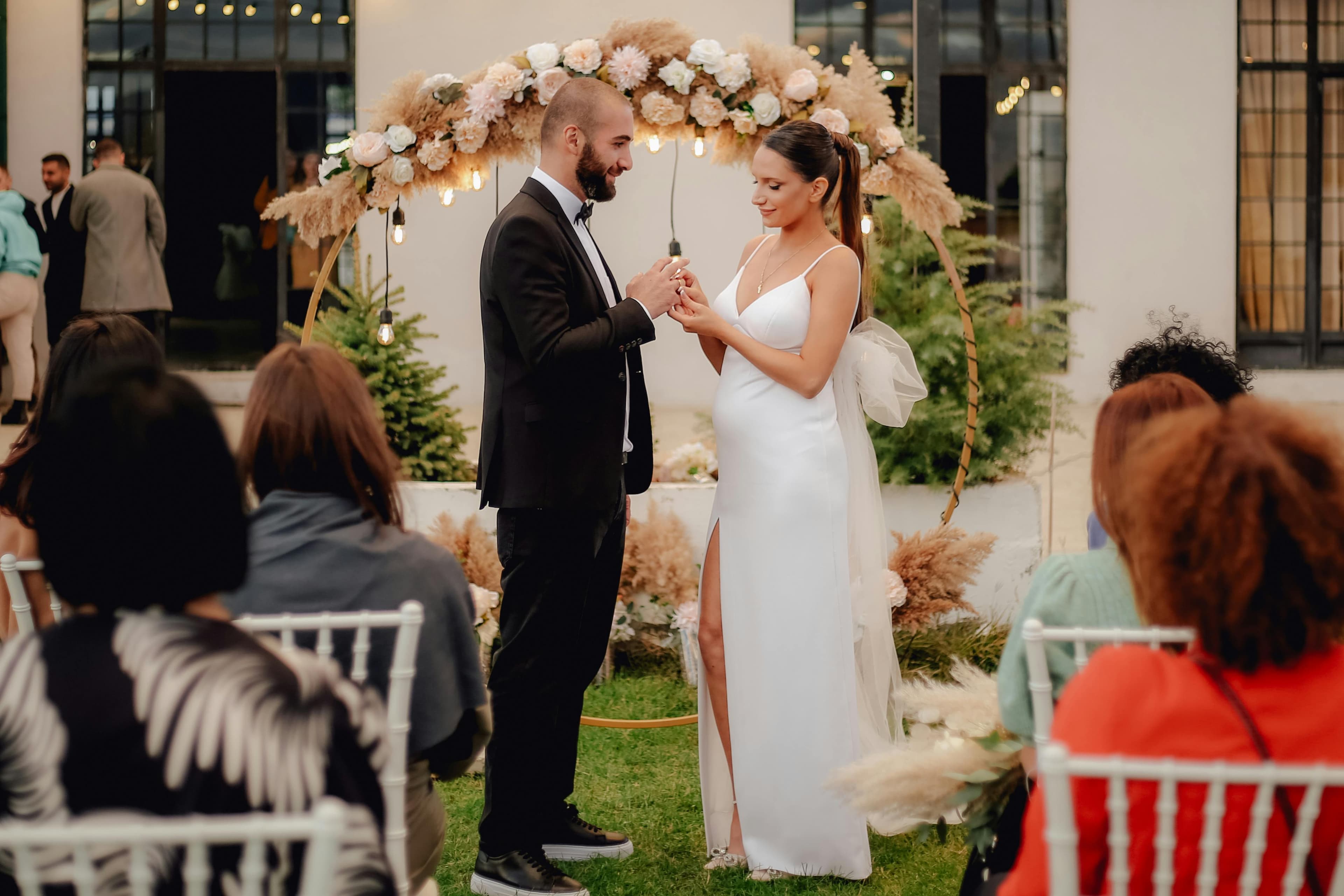 A wedding ceremony where guests are fully present without phones, watching the couple exchange vows