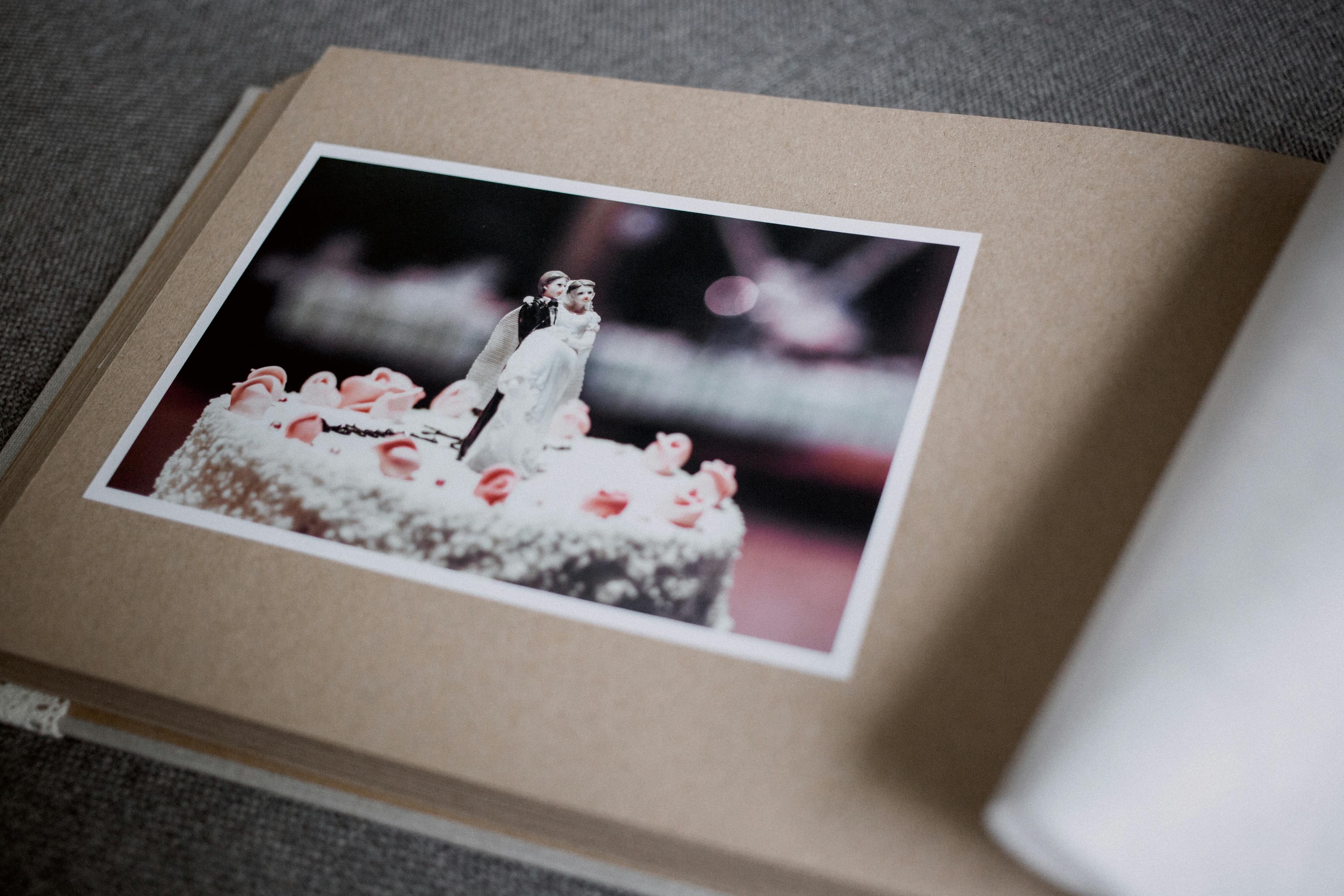 Beautiful wedding photo album open to a spread of ceremony photos
